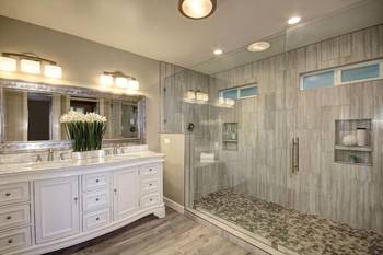 Elegant bathroom in gray and white tones with classic elements and modern shower area