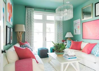 Vibrant Turquoise-Coral Living Room with Contrasting Accents and Elegant Lighting