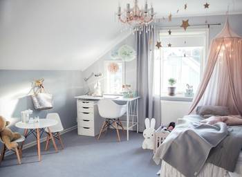 Gentle children's room in pastel tones with thoughtful zoning under a sloped roof