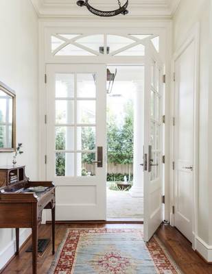 Bright classical entryway with French doors and transparent facade