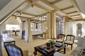 Luxurious bedroom with wooden beams and classic elements in a country house