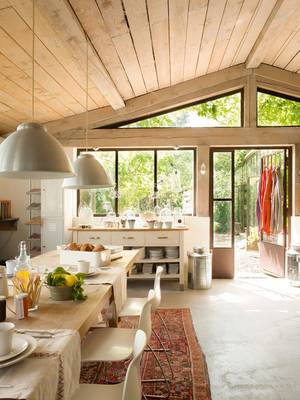 Light-filled rustic interior with panoramic glazing and open floor plan