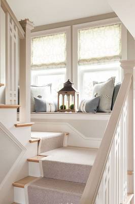 Elegant Window Seat: Functionality and Comfort on the Stair Landing