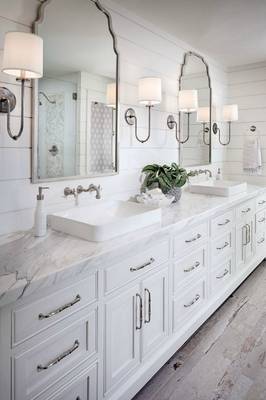 Elegant white bathroom with classic elements and marble countertop