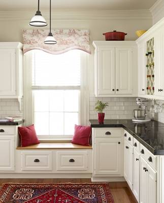 Elegant white kitchen with French accents and functional window area