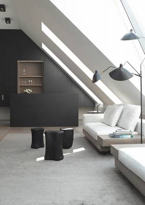Minimalist attic interior with monochromatic palette and integrated lighting