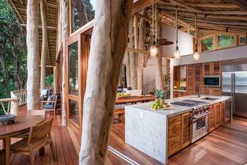 Interior design of kitchen in cottage in ethnic style.
