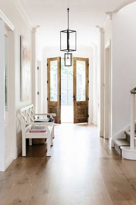 Harmonious Minimalism: Bright Hall with Wooden Doors and Classical Accents