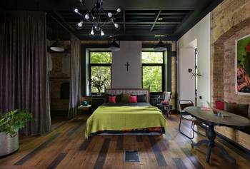 Industrial Bedroom with Spiritual Focus: Brick, Greenery and Symbolism in Modern Interior