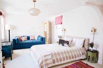 Bedroom in cottage in ethnic style.