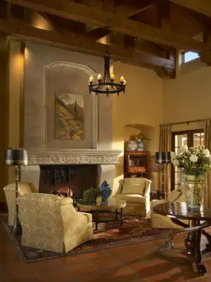 Tuscan Living Room with Beamed Ceiling and Stone Fireplace