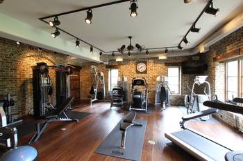 Photo of gym in house in loft style.