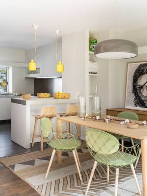 Bright minimalist interior with vibrant accents: functional kitchen-dining space connection
