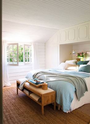 Photo of bedroom in cottage in Craftsman style.