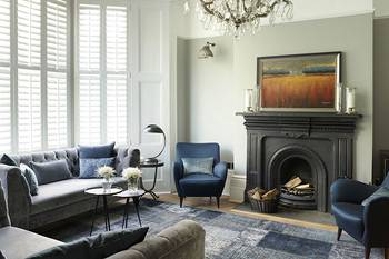 Elegant Classicism with Blue Accents: Harmonious Living Room with Historic Fireplace