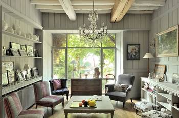 Rustic charm: gray living room with beams and panoramic window in Provence style