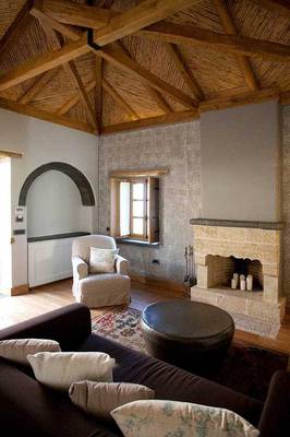 Rustic Elegance: Interior with Exposed Beams and Stone Fireplace