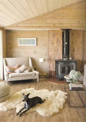 Cozy wooden interior with cast iron stove: harmony of natural materials and functionality