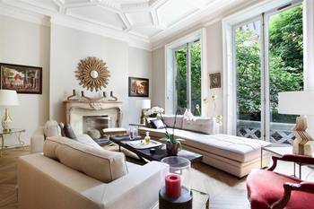 Refined Classicism: Light-Filled Living Room with French Windows and Decorative Architectural Elements