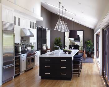 Modern Monochromatic Kitchen with Contrasting Island and Lighting Accents