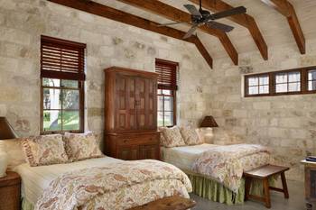 Beautiful example of bedroom in cottage in colonial style.