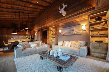 Alpine chalet with contemporary accents: warm wooden interior with natural motifs
