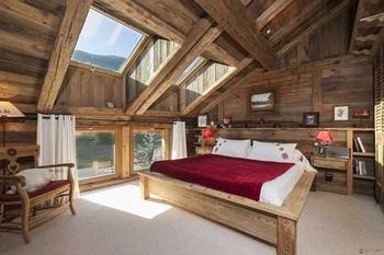 Photo of bedroom in cottage in Chalet style.